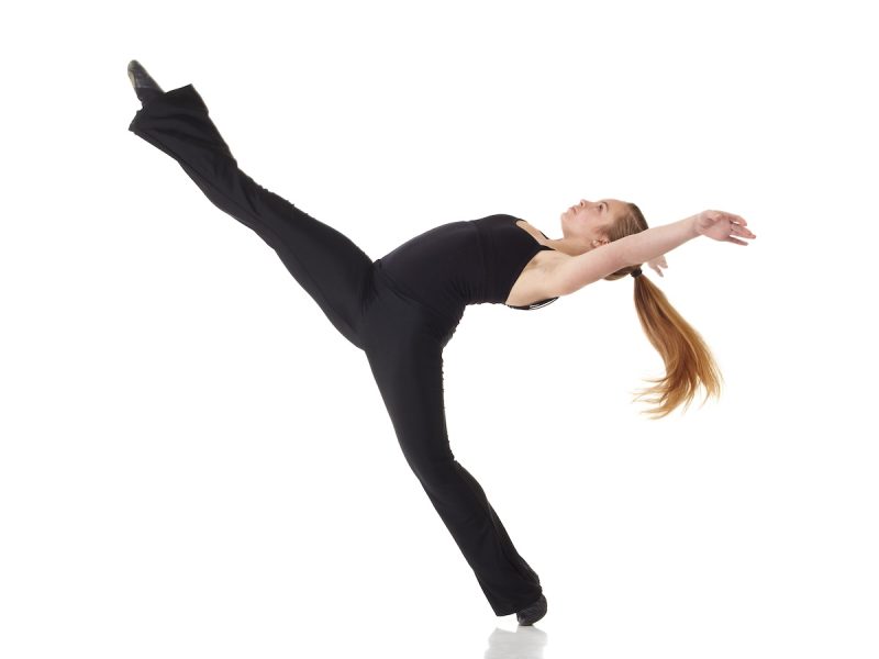Modern Jazz dancer Young caucasian Modern Jazz dancer in a black top and black pants on a white background displaying various positions. NOT ISOLATED